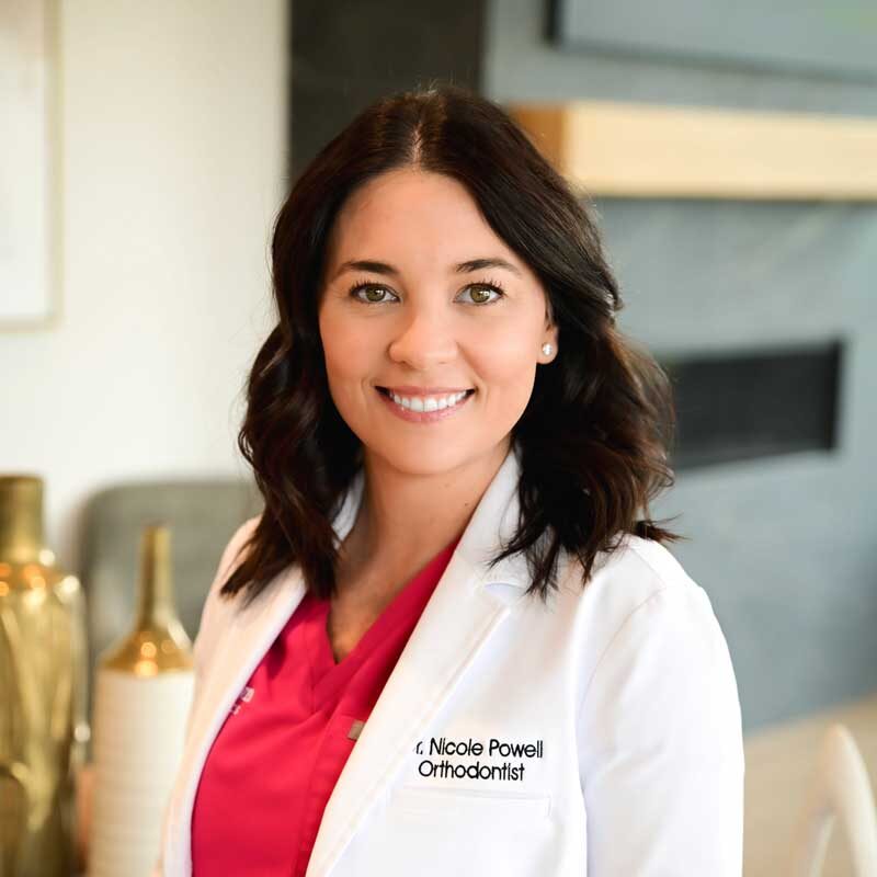 Dr. Nicole Powell in white coat